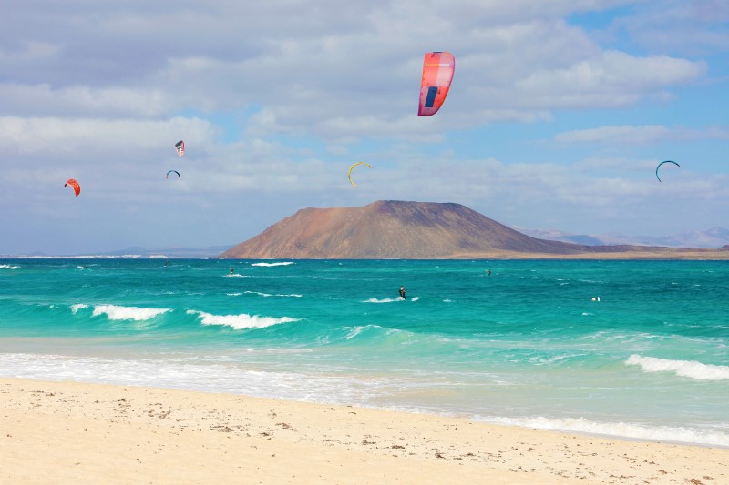 Beautiful view of Corralejo Dunas beach with Lobos Island and kitesurfers Fuerteventura Canary Islands